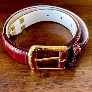 Vegan leather belt that looks like animal skin in a burgundy looking brown color
